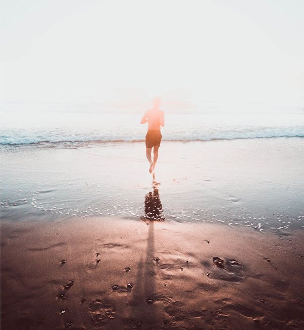 Silhouette of a person meditating at sunrise, symbolizing a journey towards wellness and balance.